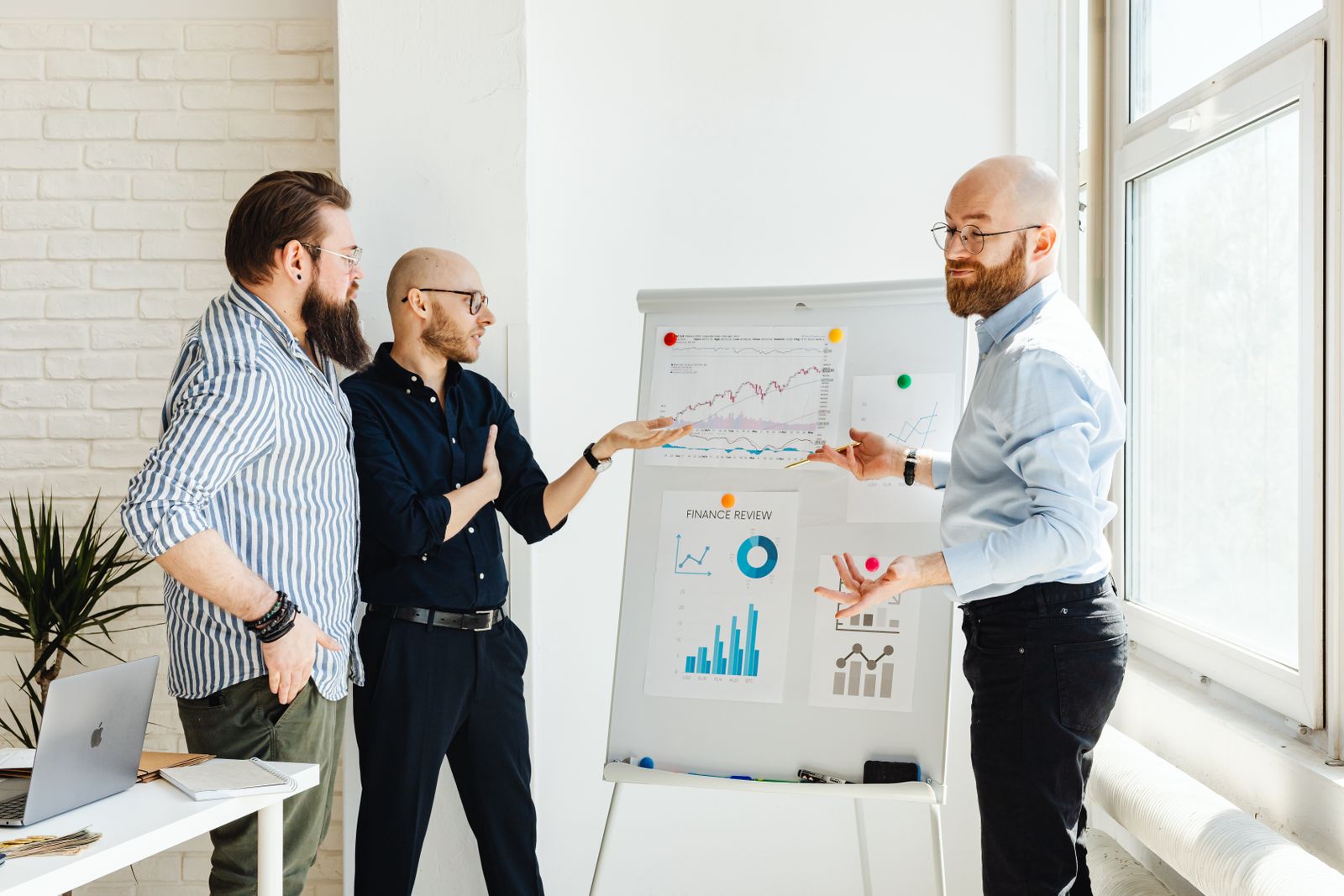 Colleagues reviewing a finance chart on a whiteboard
